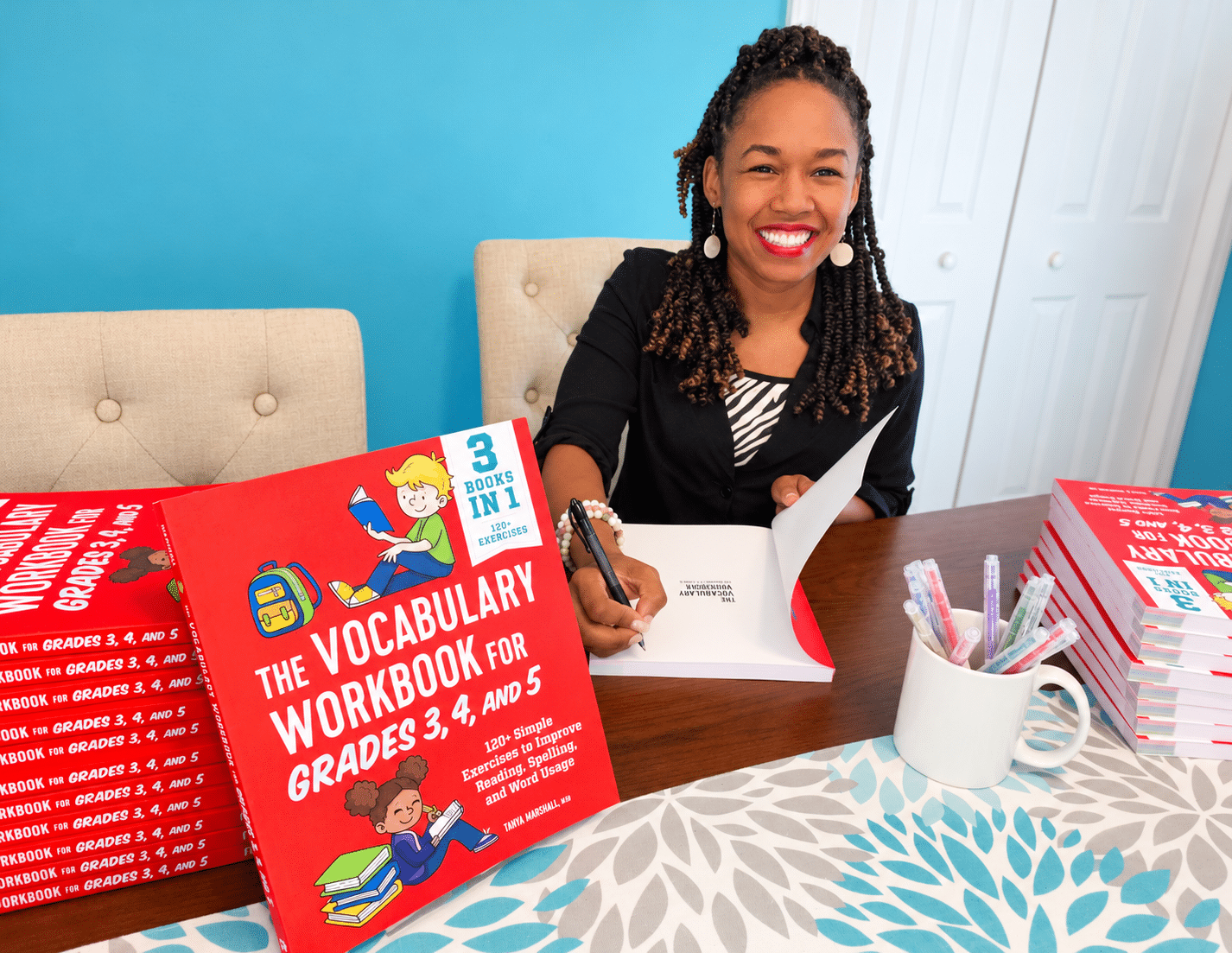 Tanya Marshall signing a copy of her vocabulary workbook